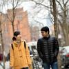 Two Temple University students walking together on campus in the winter. 