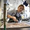 A Tyler School of Art graduate student works on metal jewelry