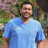 Chinmaya Agarwal pictured outside with campus scenery behind.