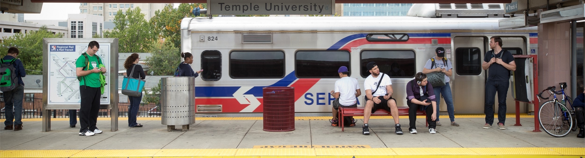 Temple University students standing on the platform at the SEPTA train station.