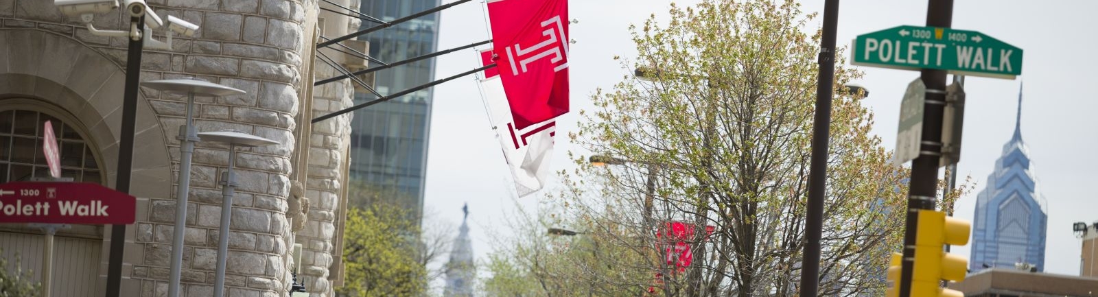 Temple University flag hanging from a building on Main Campus on Broad Street