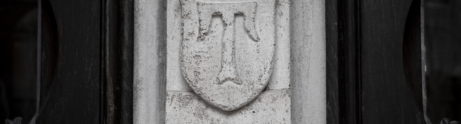 Historic Temple "T" on a stone pillar at Temple University.