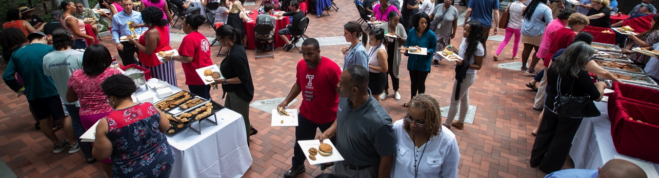 Temple University staff celebrate another successful year during a summer BBQ.