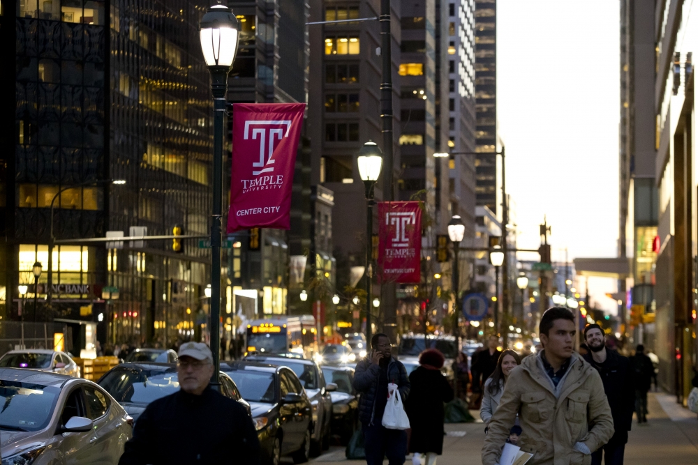 Temple University flags hang from street light poles in Center City Philadelphia.